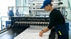 womanworkerintheproductionofplasticpackagingfoldsfinished