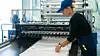 womanworkerintheproductionofplasticpackagingfoldsfinished