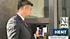 businessman-disarming-security-system-of-door-with-smartphone