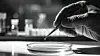 Black and white fine art photograph of a scientists hand holding